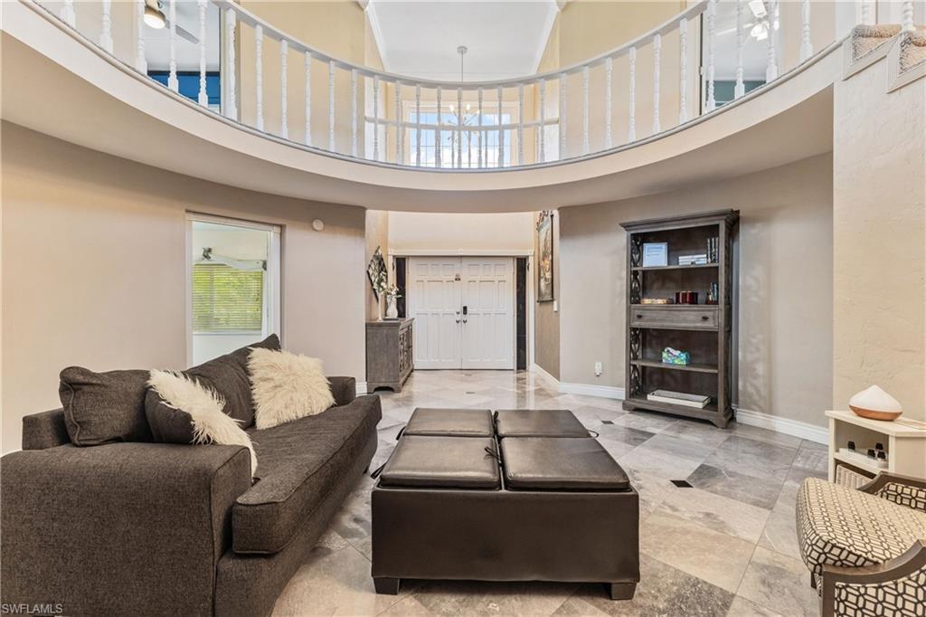 8012 Kansas Road Fort Myers, FL 33967 - Photo 8 of 44 Living room with ceiling fan and a high ceiling