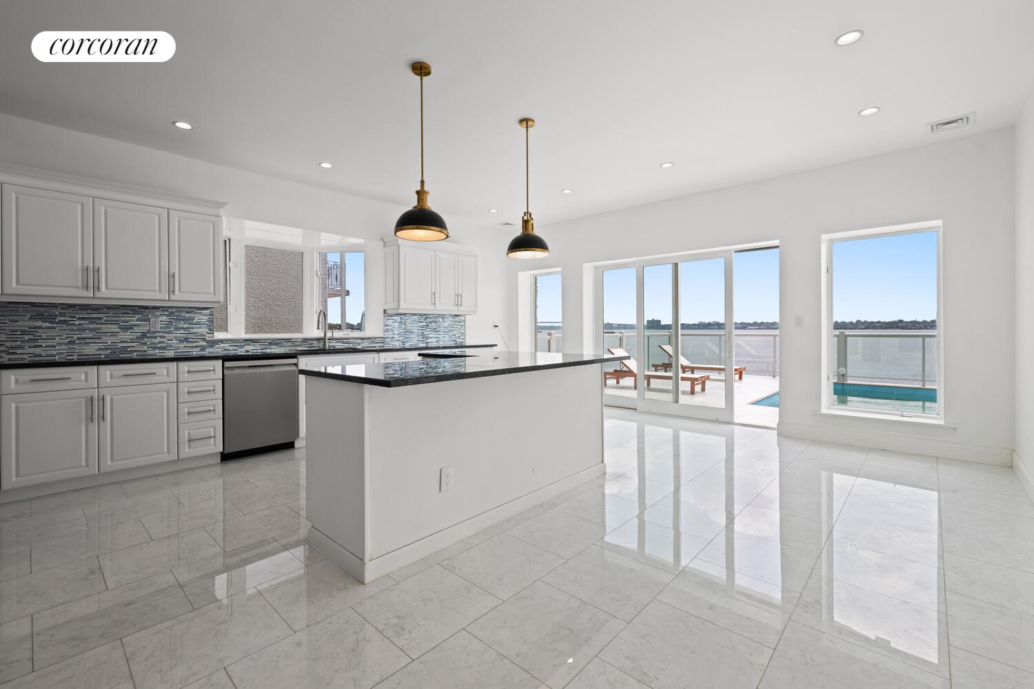 4 Angelas Place Bronx, NY 10026 - Photo 11 of 68 a kitchen with stainless steel appliances granite countertop a stove top oven a sink a counter space and cabinets