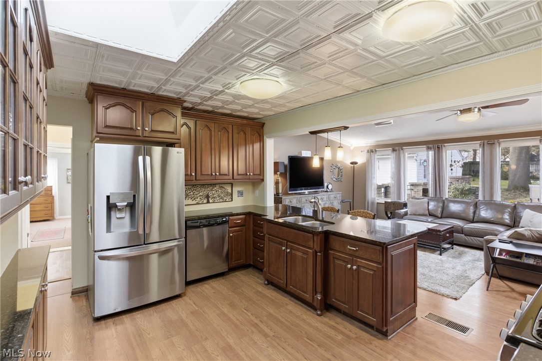 Large, open kitchen with granite counter tops, newer SS appliances, breakfast bar and open to family with access to the back yard and patio area.
