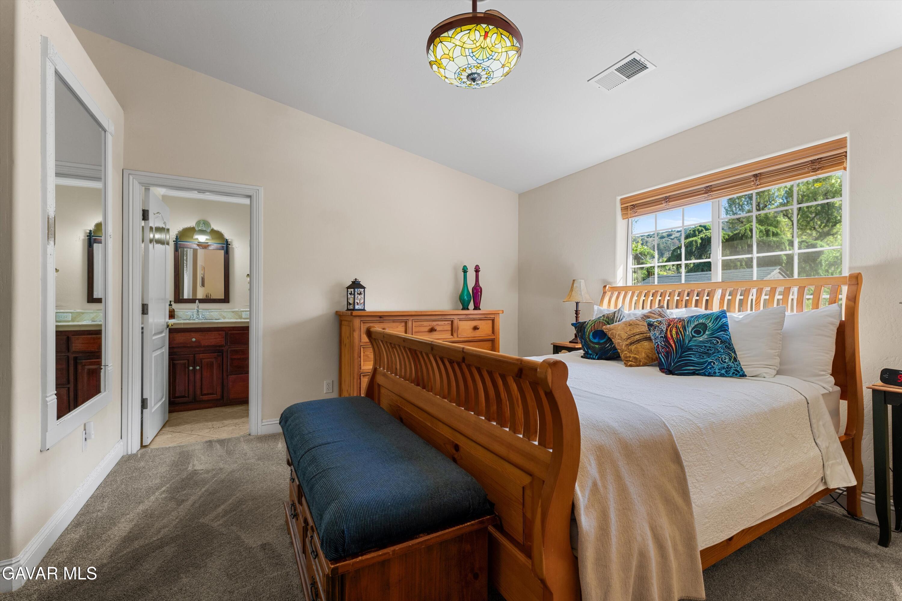 18250 Arosa Road Tehachapi, CA 93561 - Photo 24 of 71 a bedroom with furniture and a chandelier