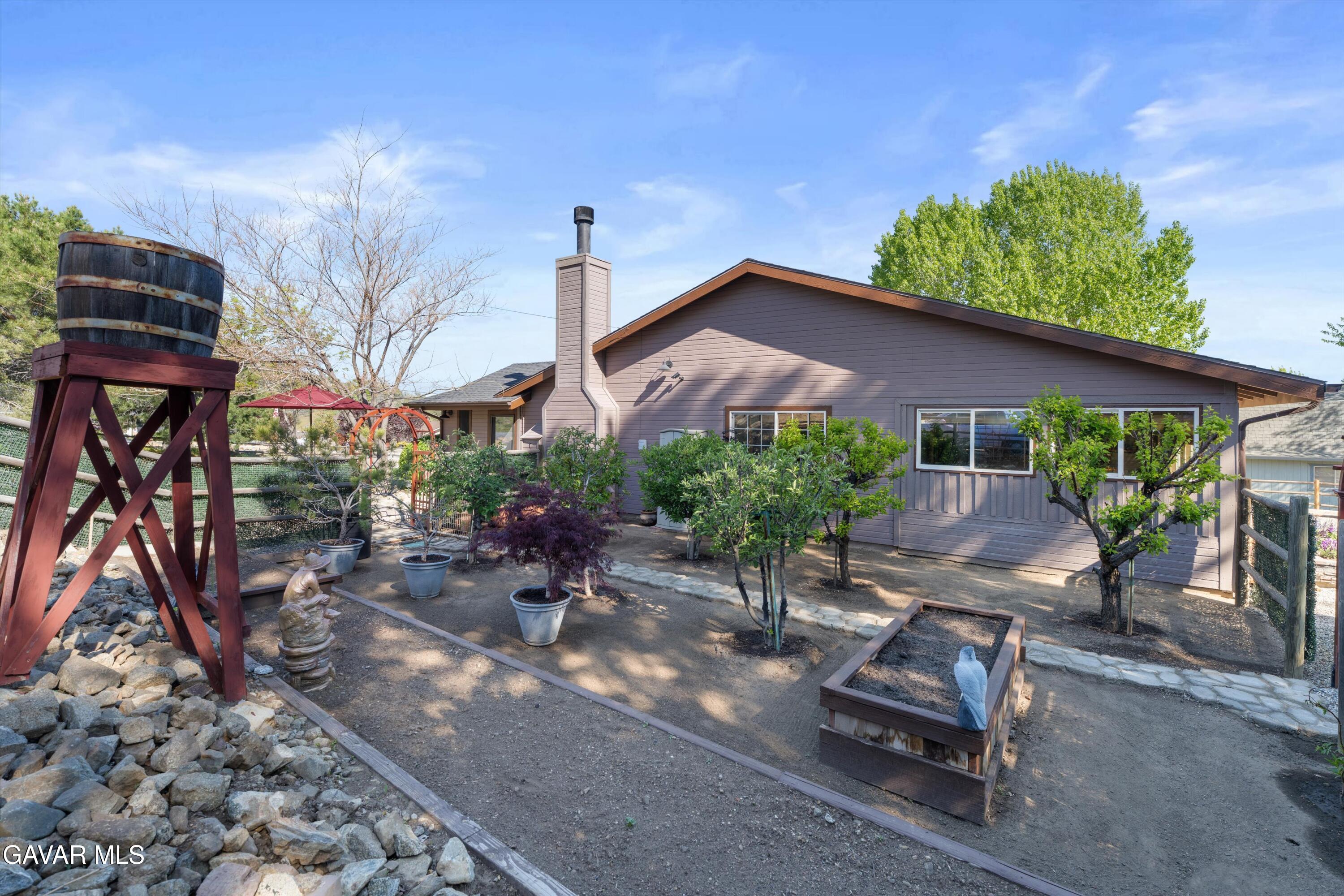 18250 Arosa Road Tehachapi, CA 93561 - Photo 38 of 71 a view of a chairs and table in a backyard