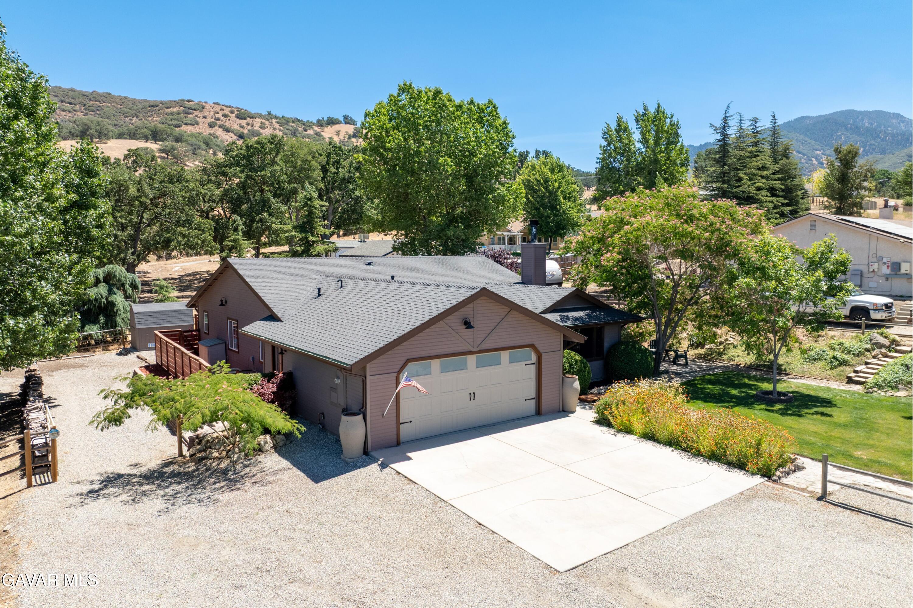 18250 Arosa Road Tehachapi, CA 93561 - Photo 52 of 71 an aerial view of a house with a yard and garage