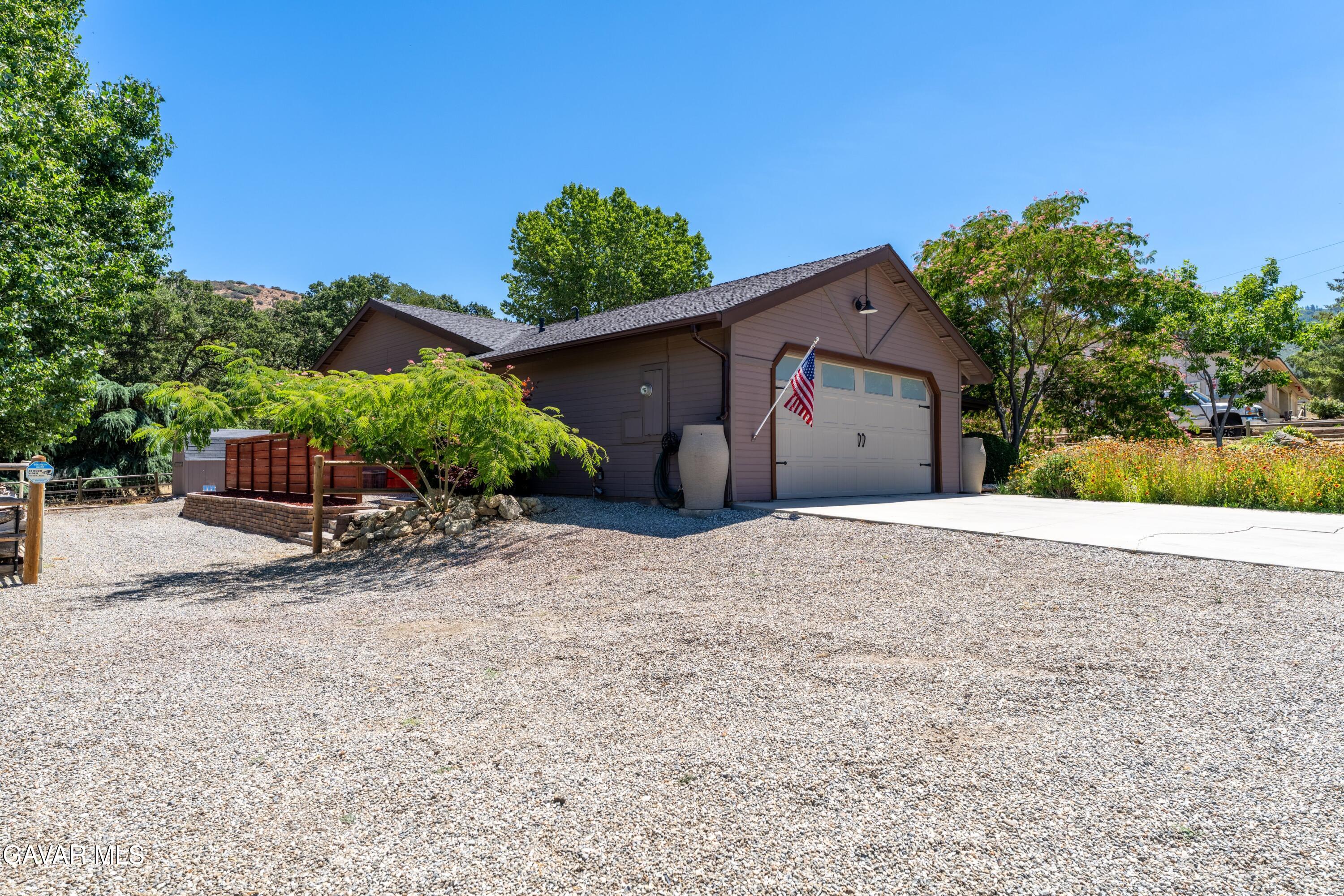 18250 Arosa Road Tehachapi, CA 93561 - Photo 64 of 71 a front view of a house with a yard and a garage
