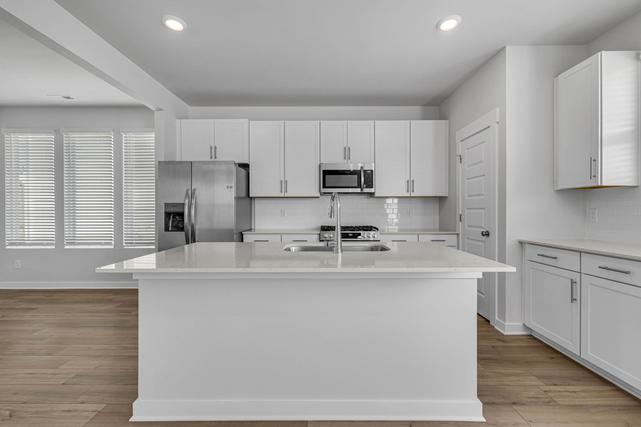 219 Goldfinch Road Mount Juliet, TN 37122 - Photo 12 of 58 a kitchen with kitchen island white cabinets and white appliances