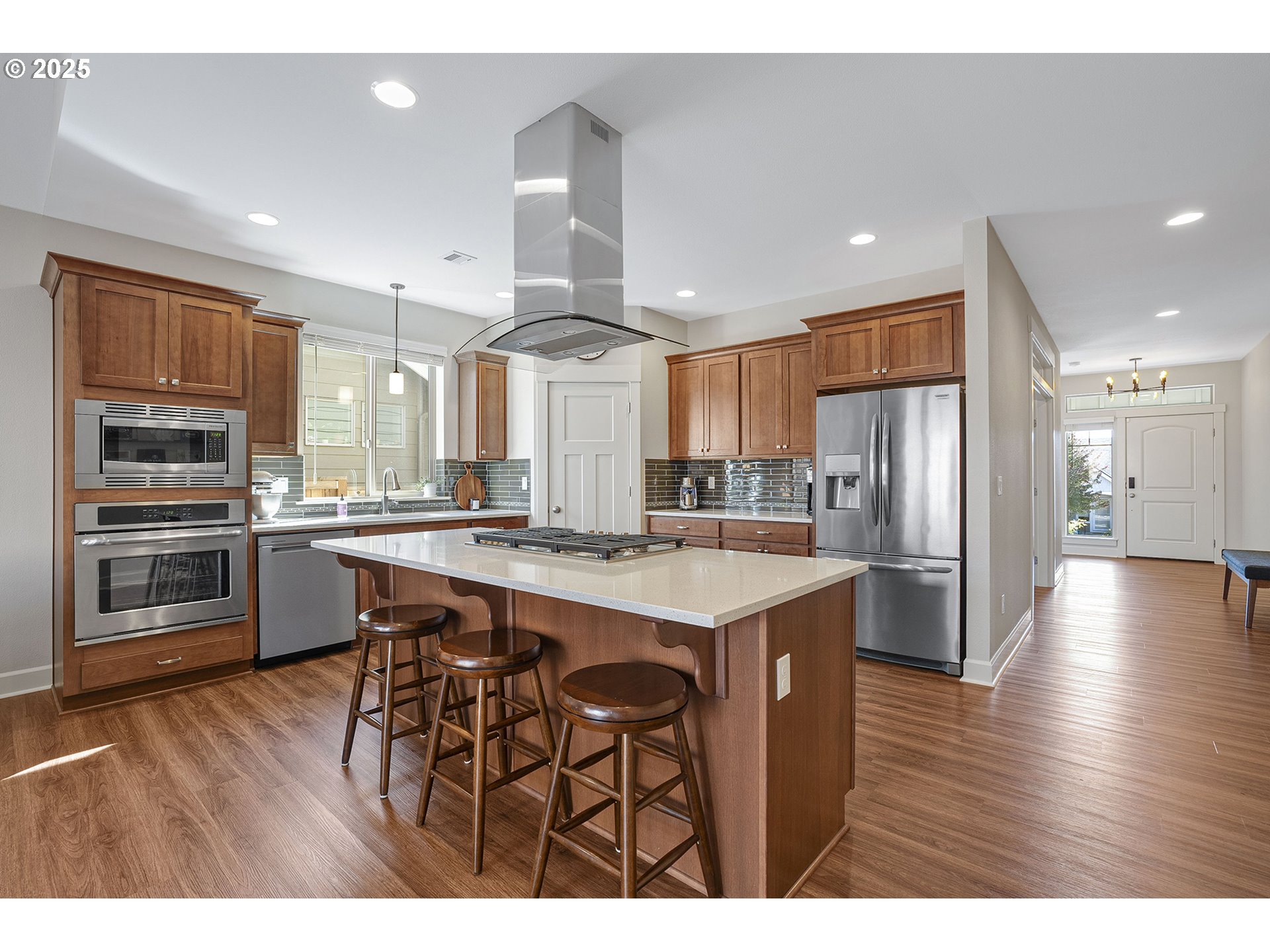 3571 Southwest 31st Street Gresham, OR 97080 - Photo 12 of 37 a kitchen with stainless steel appliances a refrigerator a stove a sink cabinets and wooden floor