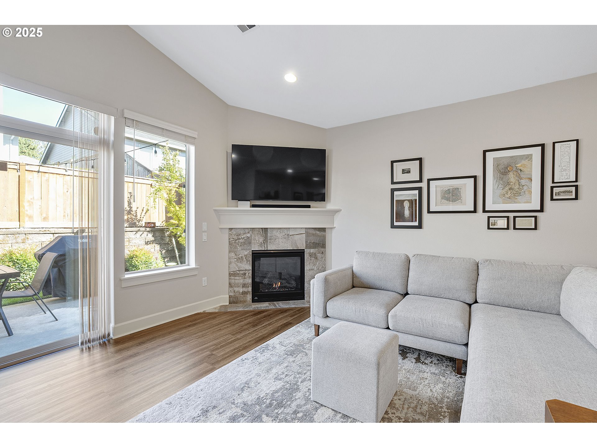 3571 Southwest 31st Street Gresham, OR 97080 - Photo 19 of 37 a living room with furniture a flat screen tv and a fireplace