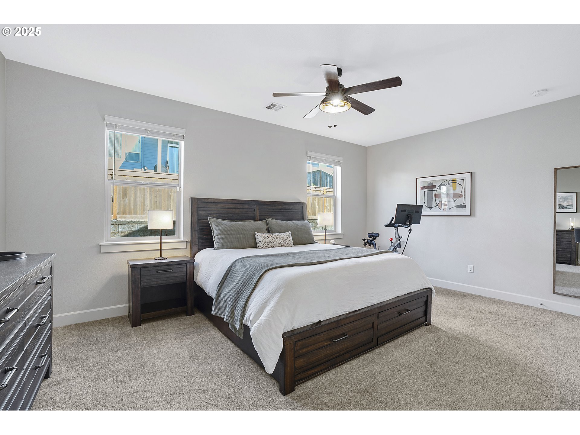 3571 Southwest 31st Street Gresham, OR 97080 - Photo 23 of 37 a bedroom with a bed painting on wall and two windows
