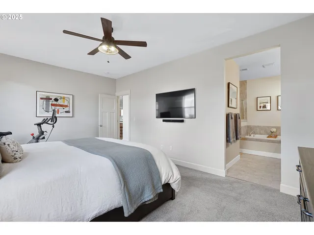 a bedroom with a bed and a tv