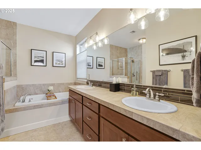a bathroom with a sink double vanity granite and a bathtub