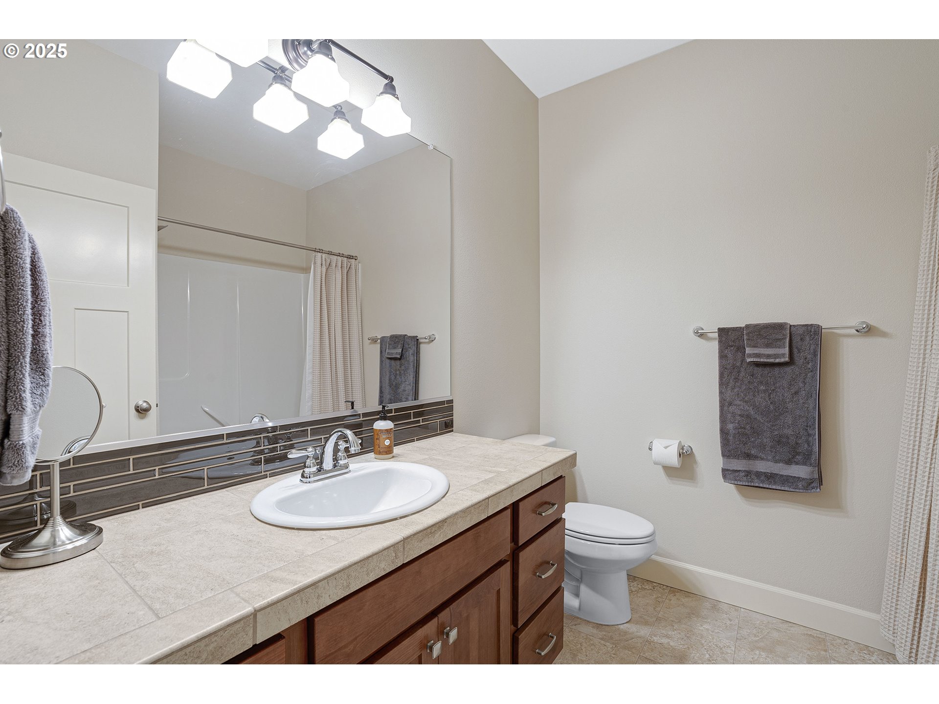3571 Southwest 31st Street Gresham, OR 97080 - Photo 32 of 37 a bathroom with a granite countertop sink a toilet and a mirror