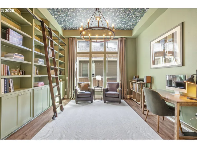 a living room with furniture and a floor to ceiling window