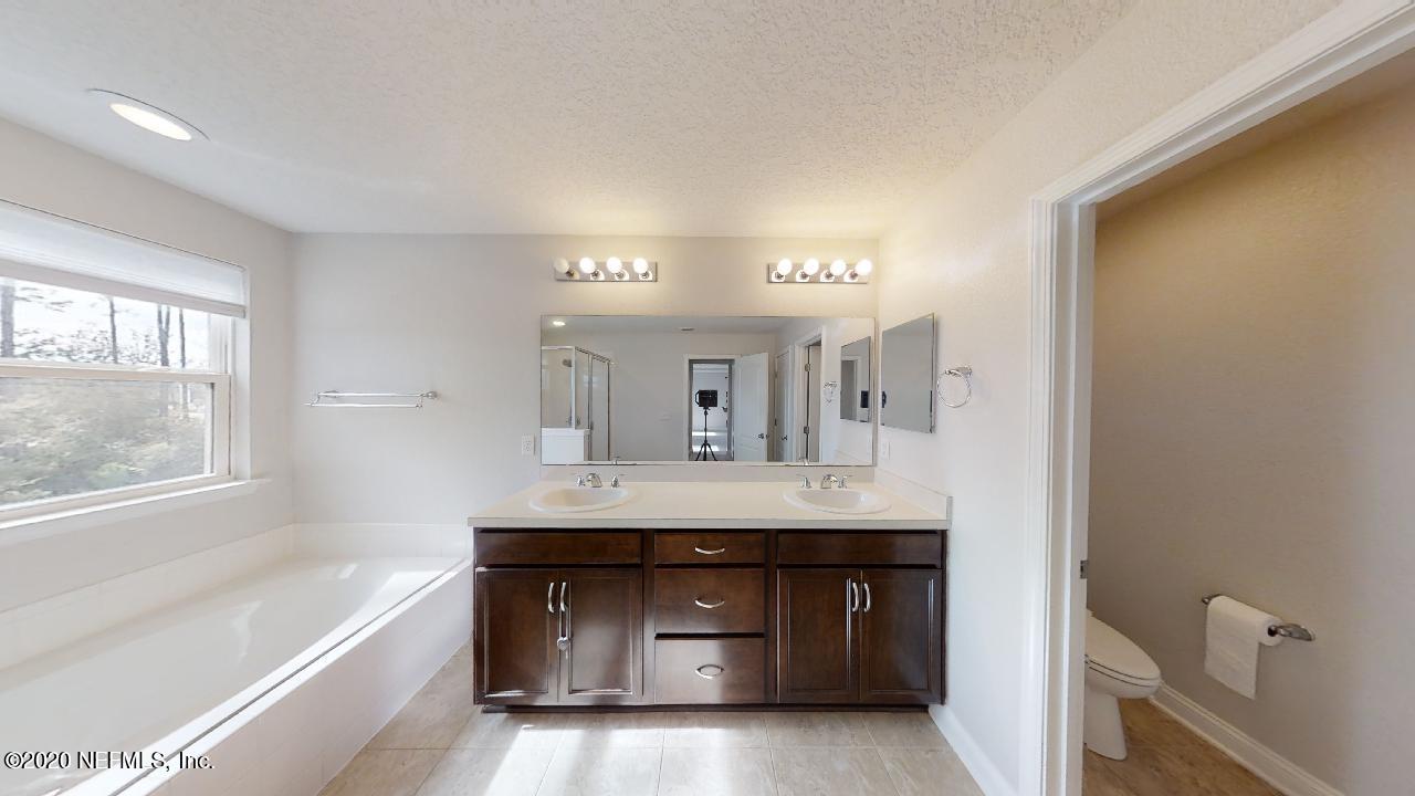 6690 Azalea Park Road Jacksonville, FL 32259 - Photo 25 of 47 a bathroom with a sink and a large mirror