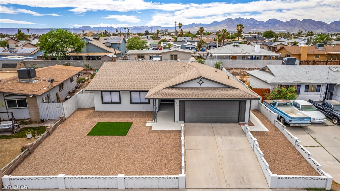 324 Lakehurst Road Las Vegas, NV 89145 - Photo 25 of 30 A low-maintenance gravel front yard frames this single-story home set against a mountain backdrop.