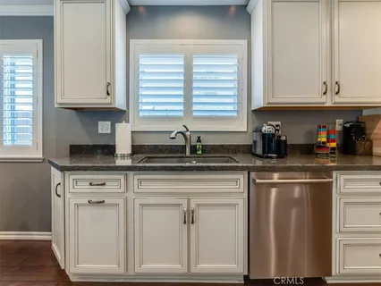 a stove top oven sitting inside of a kitchen