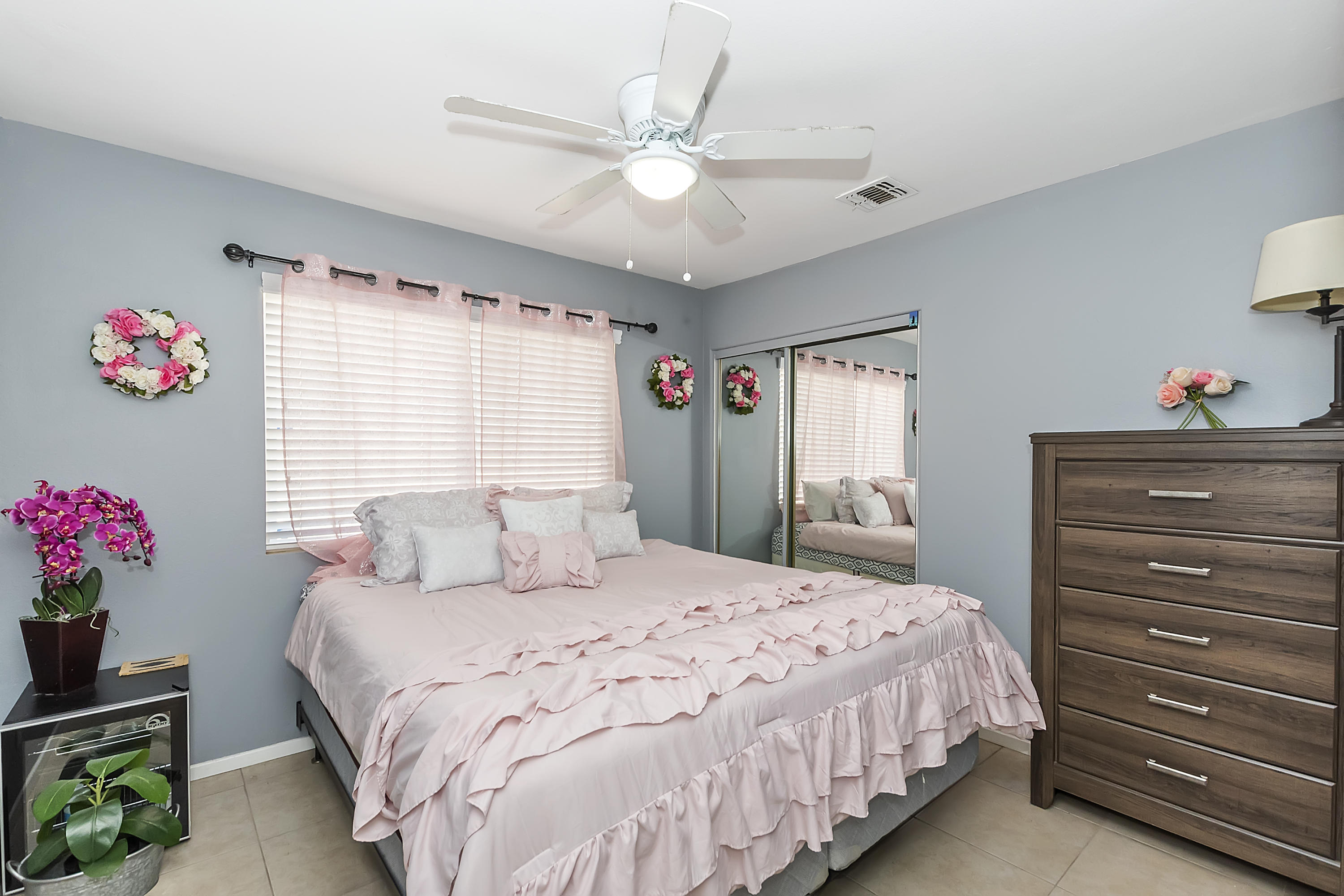 13140 Zane Way Whitewater, CA 92282 - Photo 15 of 25 a bedroom with a bed a dresser and a chandelier
