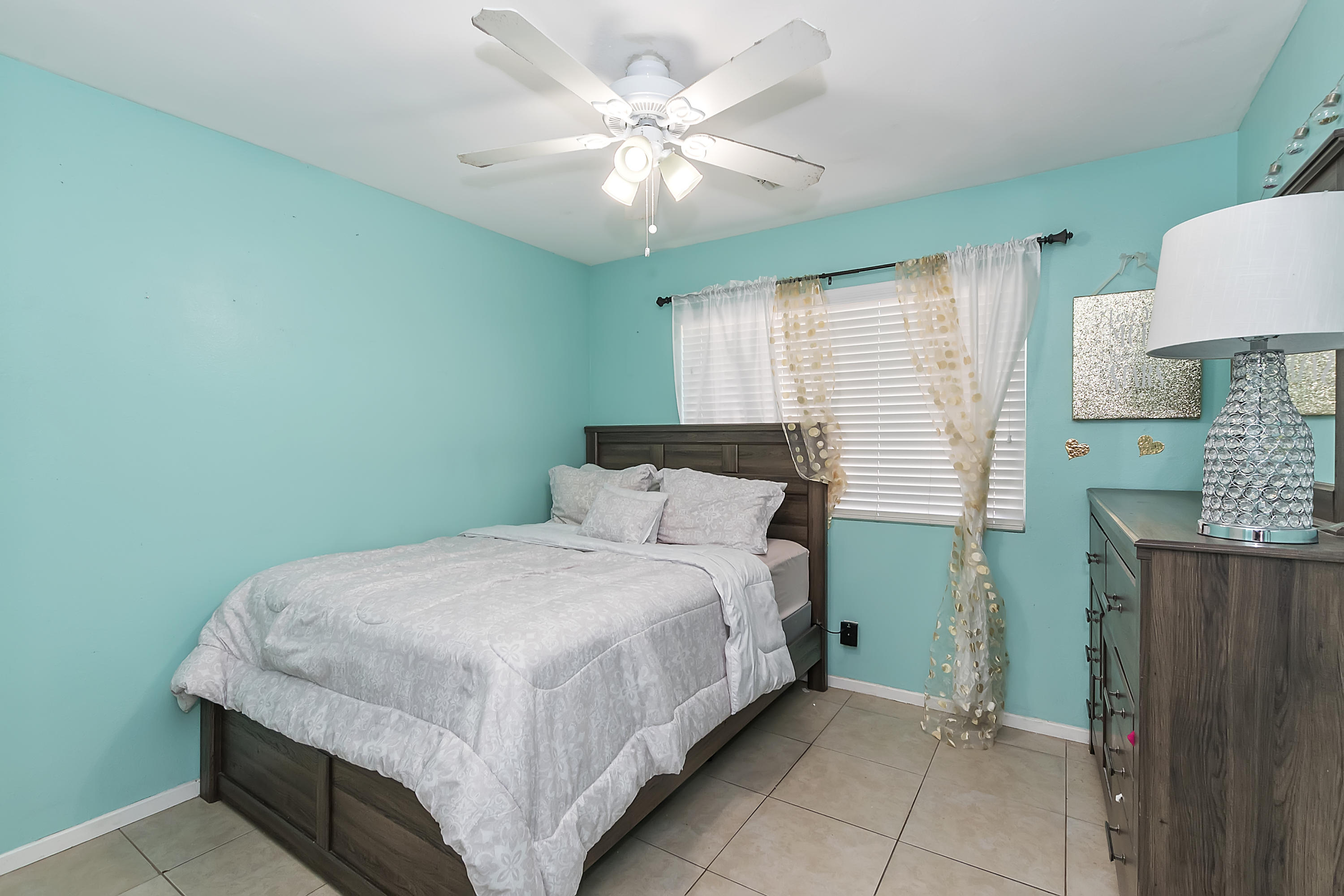 13140 Zane Way Whitewater, CA 92282 - Photo 16 of 25 a bedroom with a bed chandelier and a window