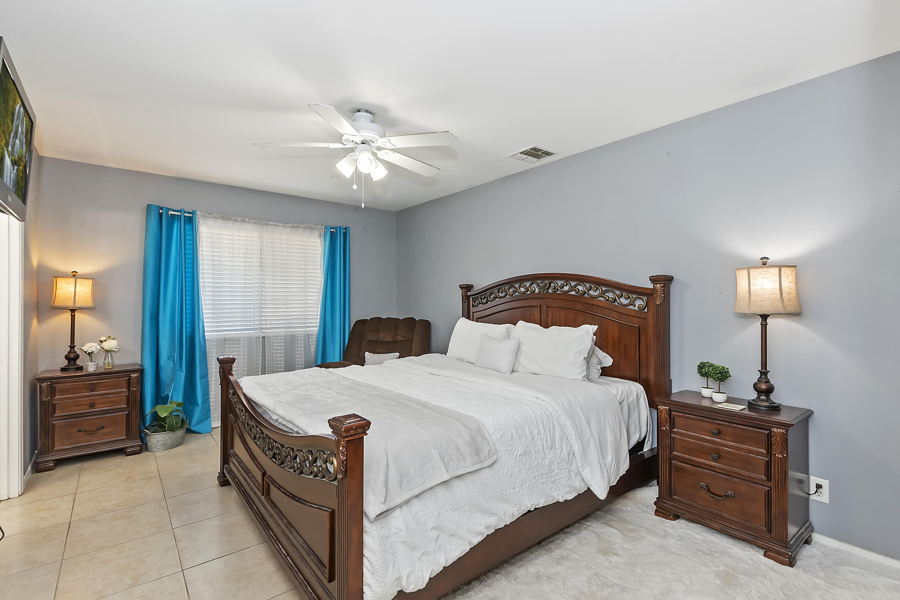 13140 Zane Way Whitewater, CA 92282 - Photo 17 of 25 a bedroom with a bed and a chandelier