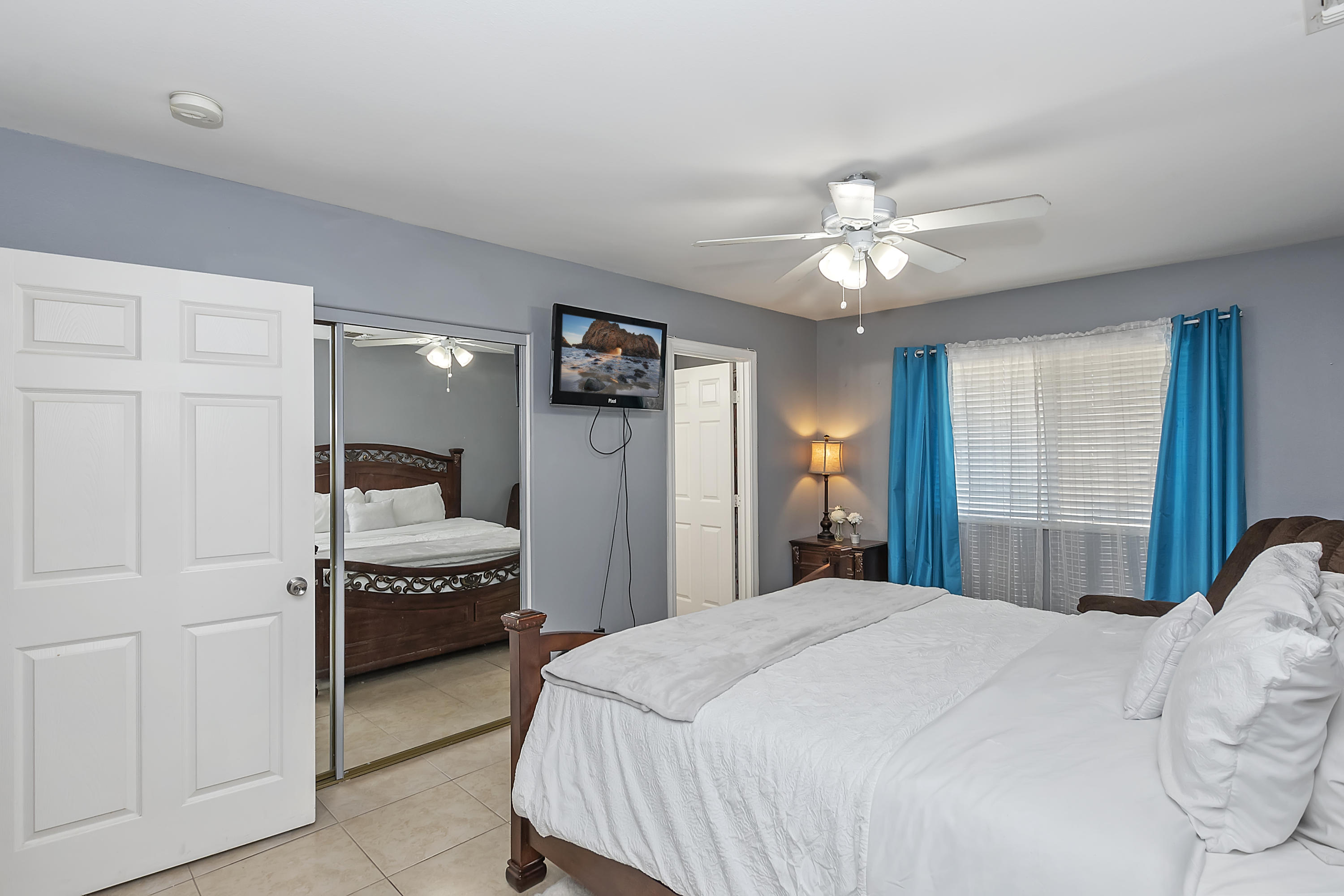 13140 Zane Way Whitewater, CA 92282 - Photo 19 of 25 a bedroom with a bed and a chandelier