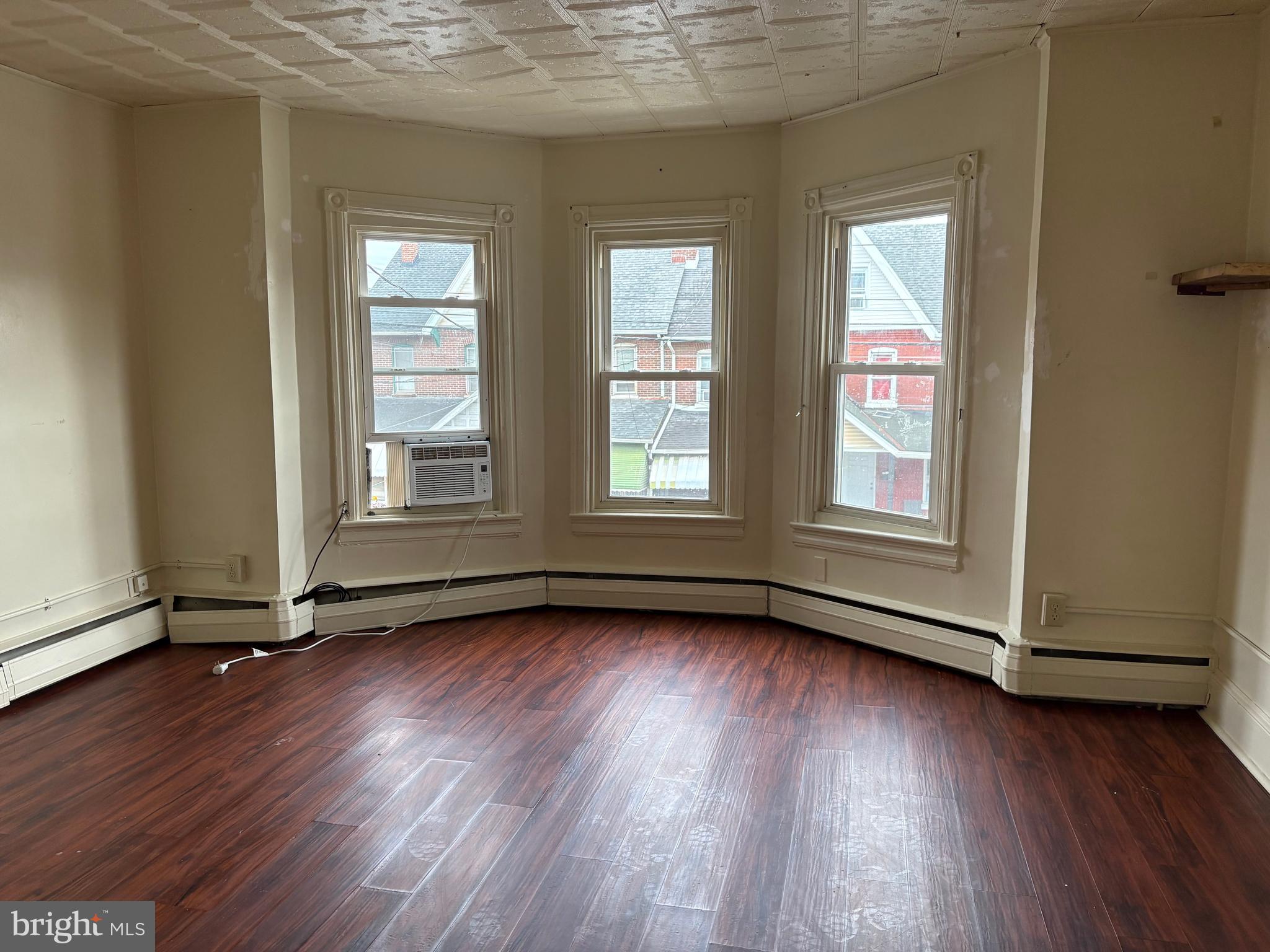 114 Strode Avenue Coatesville, PA 19320 - Photo 11 of 16 an empty room with wooden floor and windows