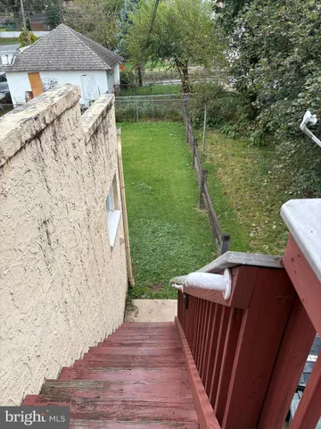 a view of a backyard with sitting area