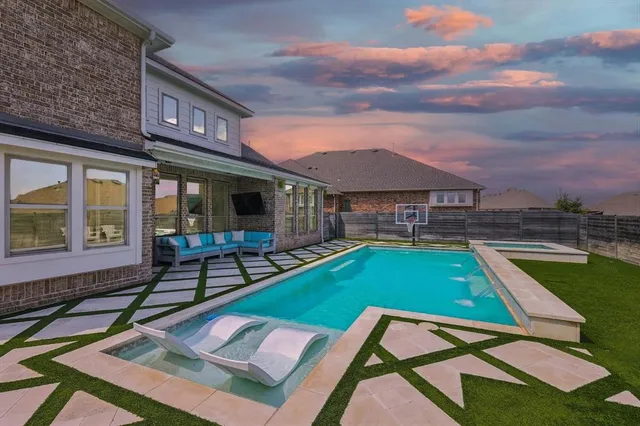 a backyard of a house with barbeque oven table and chairs
