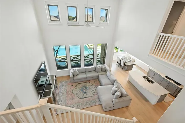 a living room with furniture and a floor to ceiling window