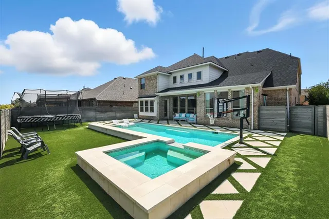 a view of swimming pool with seating space and barbeque oven