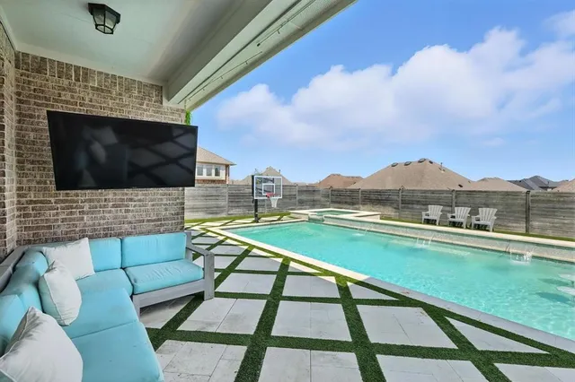 a outdoor living space with furniture and a flat screen tv