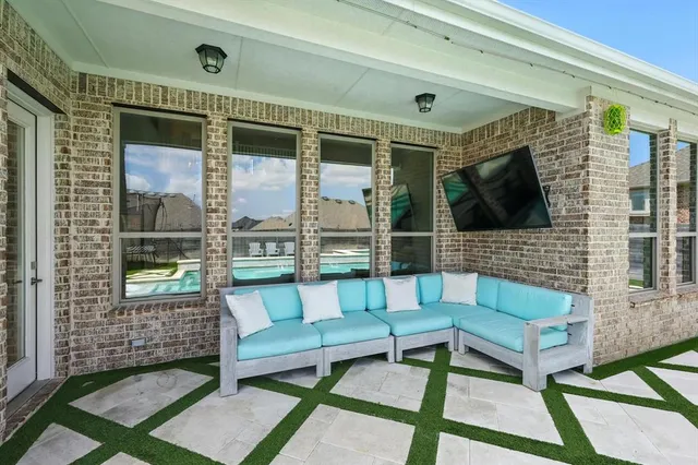 a view of swimming pool with seating area and barbeque oven