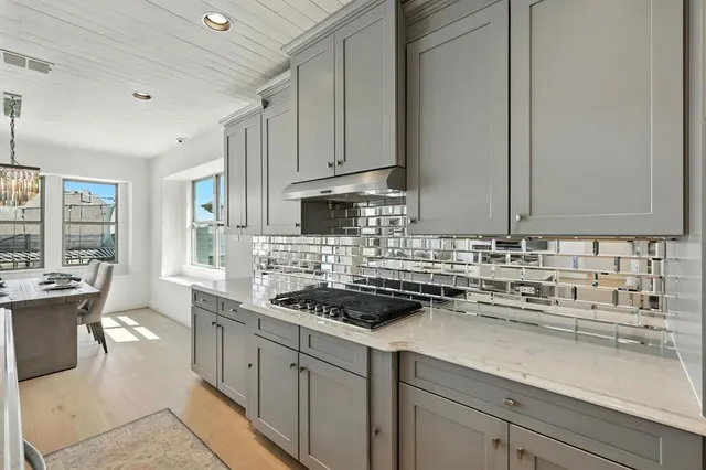 a kitchen with stainless steel appliances granite countertop a sink stove and cabinets