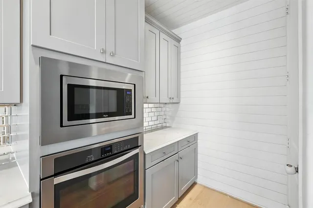 a kitchen with granite countertop white cabinets stainless steel appliances and sink