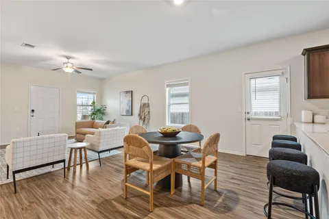 a view of a dining room with furniture and wooden floor