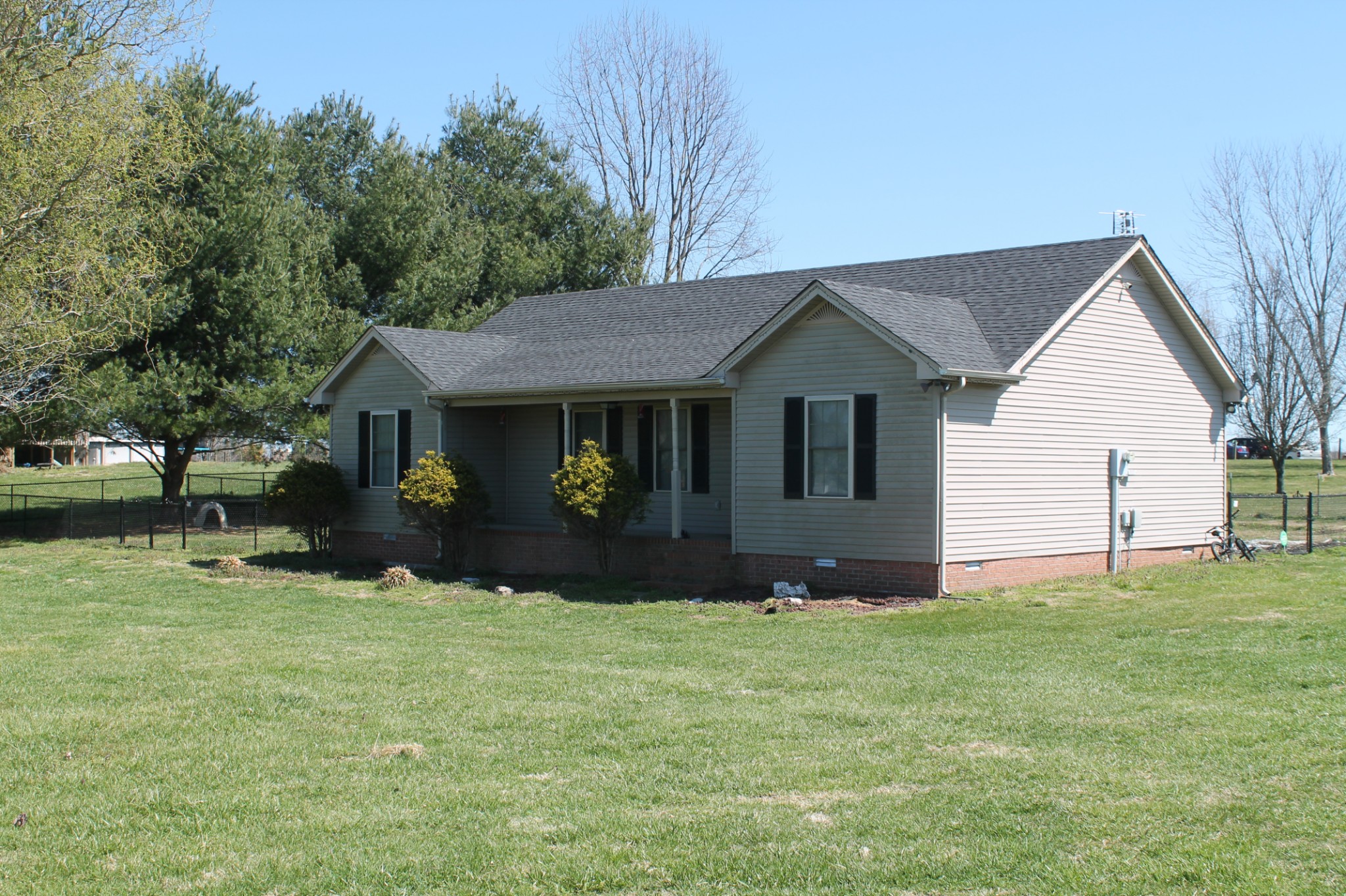 3610 Galen Road Lafayette, TN 37083 - Photo 3 of 16 a front view of a house with a yard and trees