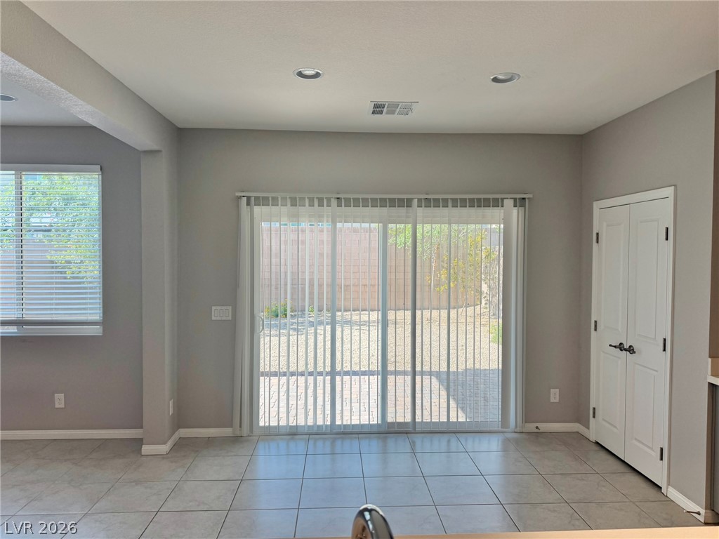 9953 Tucket Point Court Las Vegas, NV 89178 - Photo 6 of 22 Sliding doors provide seamless indoor-outdoor access to a private yard, enhancing the living area's appeal.