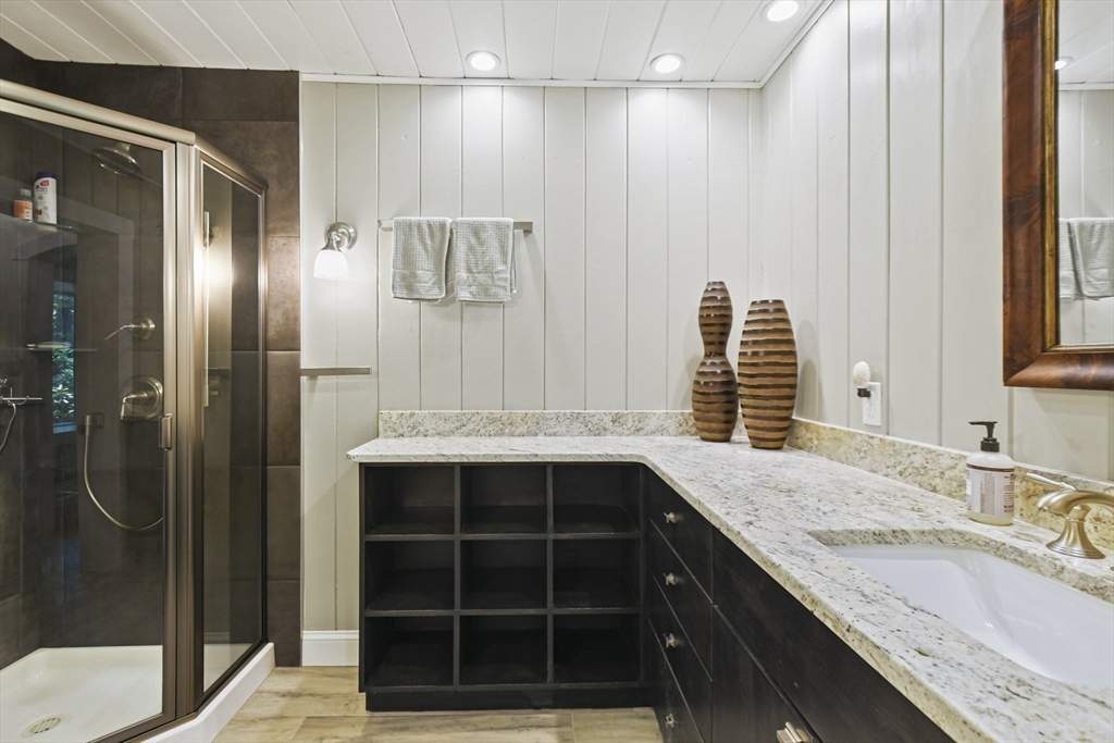 67 Bennetts Road Sturbridge, MA 01566 - Photo 18 of 42 a bathroom with a granite countertop sink and a mirror