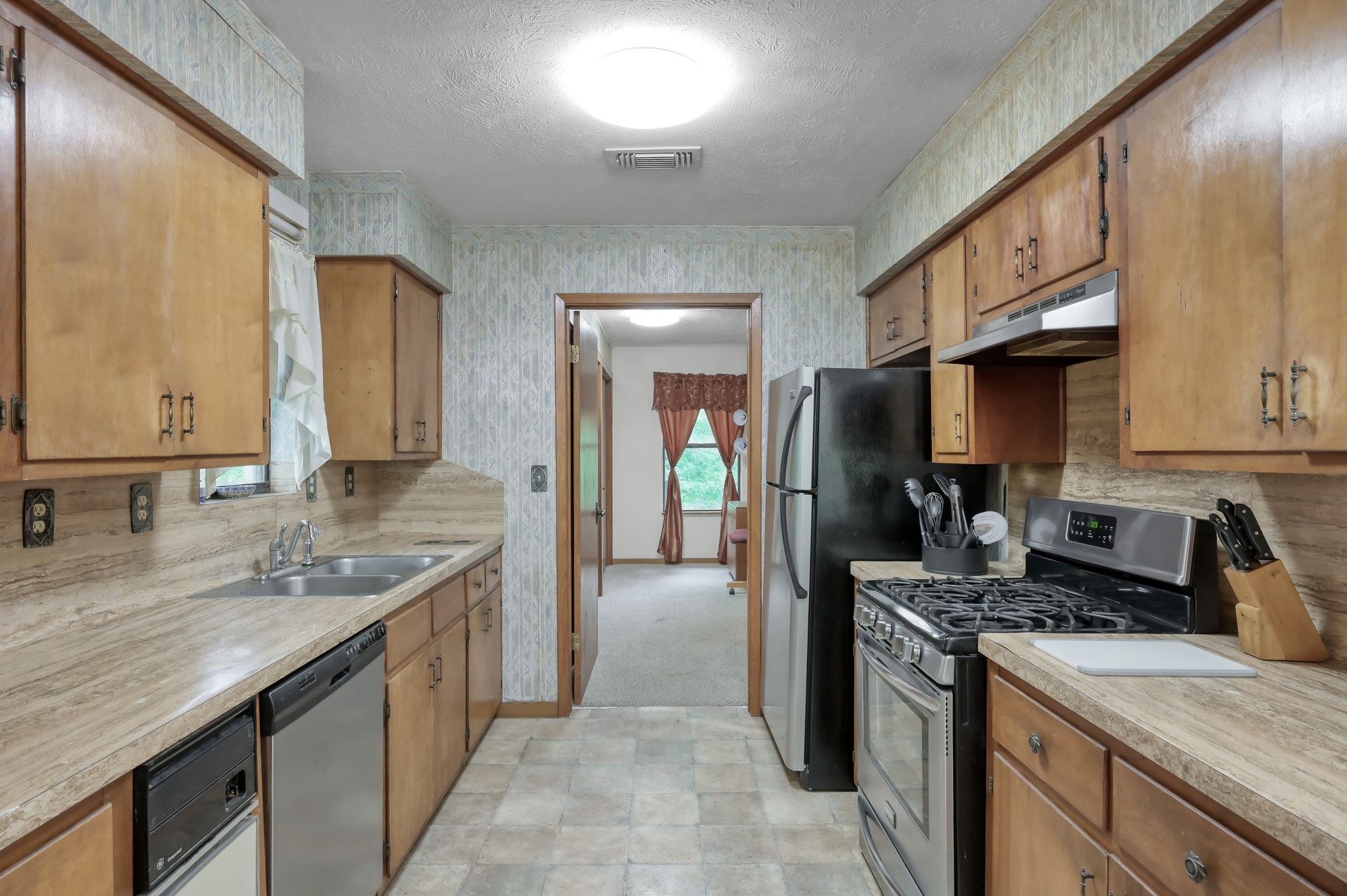254 Sharp Lane Trinity, TX 75862 - Photo 13 of 36 a kitchen with stainless steel appliances granite countertop a sink stove and refrigerator