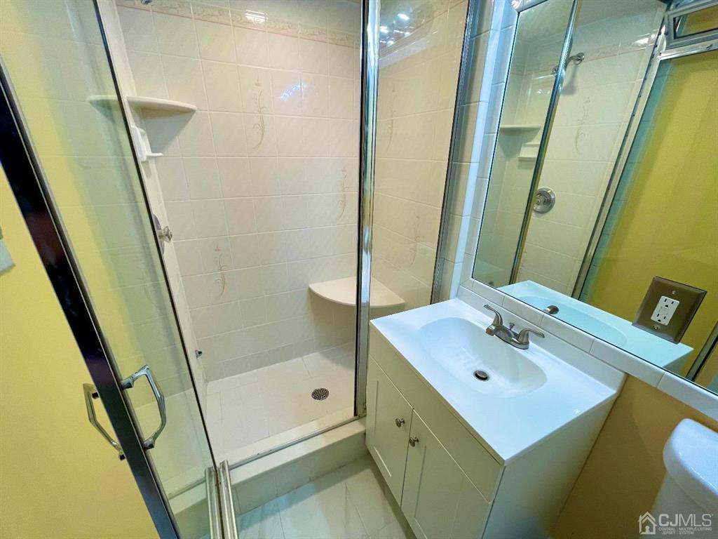 5 Greenwich Road Edison, NJ 08820 - Photo 17 of 52 a bathroom with a sink mirror and shower