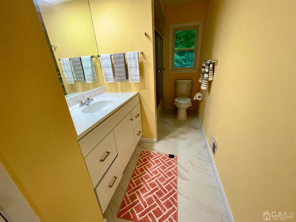 5 Greenwich Road Edison, NJ 08820 - Photo 18 of 52 a bathroom with a sink and a toilet