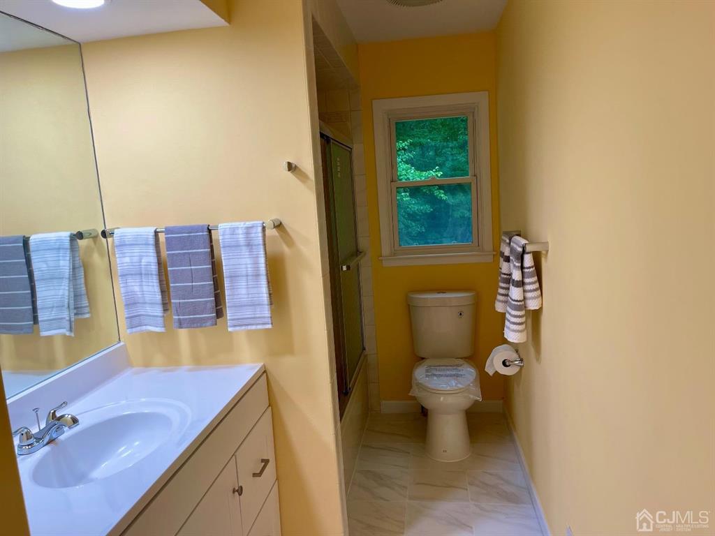5 Greenwich Road Edison, NJ 08820 - Photo 19 of 52 a bathroom with a sink and a toilet