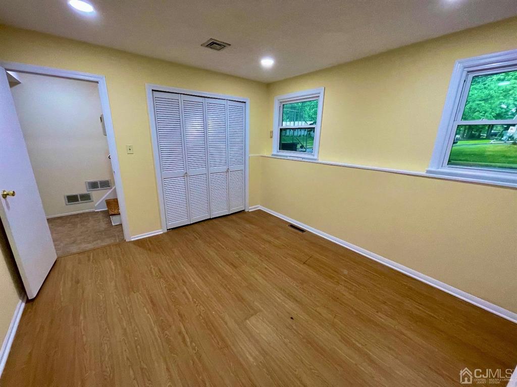 5 Greenwich Road Edison, NJ 08820 - Photo 34 of 52 an empty room with wooden floor and windows