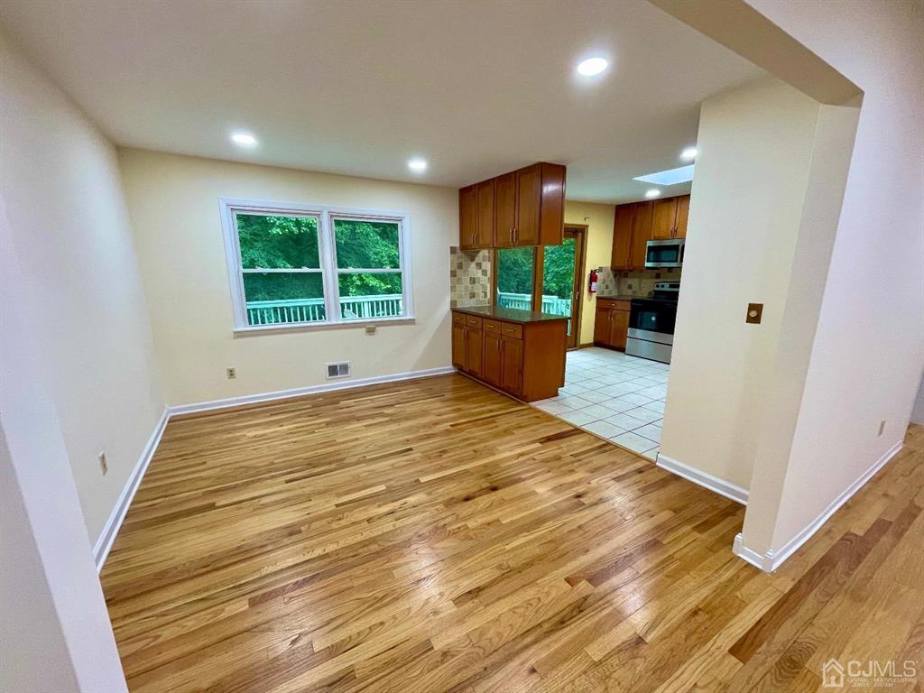 5 Greenwich Road Edison, NJ 08820 - Photo 4 of 52 a view of an empty room with wooden floor and a window