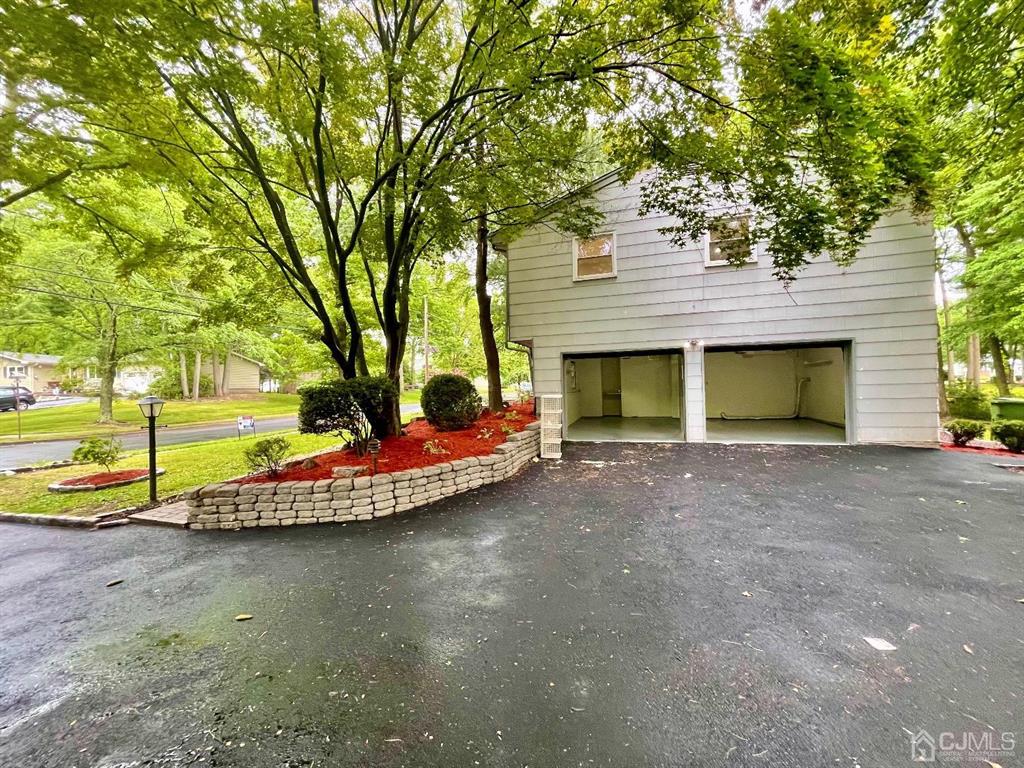 5 Greenwich Road Edison, NJ 08820 - Photo 48 of 52 a view of a house with a yard and garage