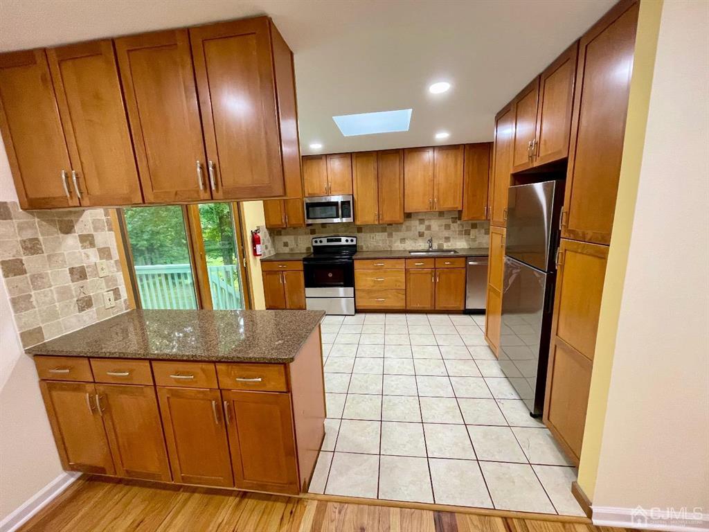 5 Greenwich Road Edison, NJ 08820 - Photo 5 of 52 a kitchen with stainless steel appliances granite countertop wooden cabinets a stove a sink and dishwasher