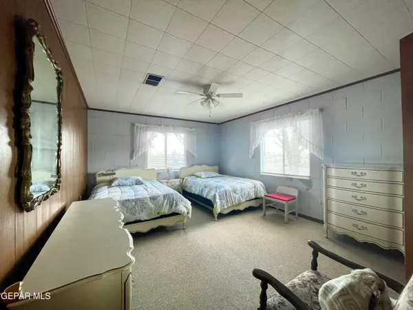 a bedroom with a bed and a tv