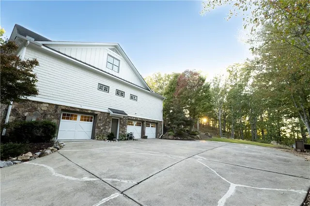 an empty room with wooden floor fireplace and windows
