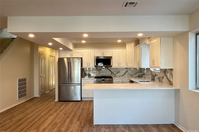 a kitchen with a sink appliances and cabinets