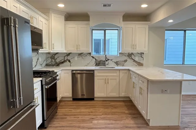 a kitchen with stainless steel appliances granite countertop a sink stove and refrigerator