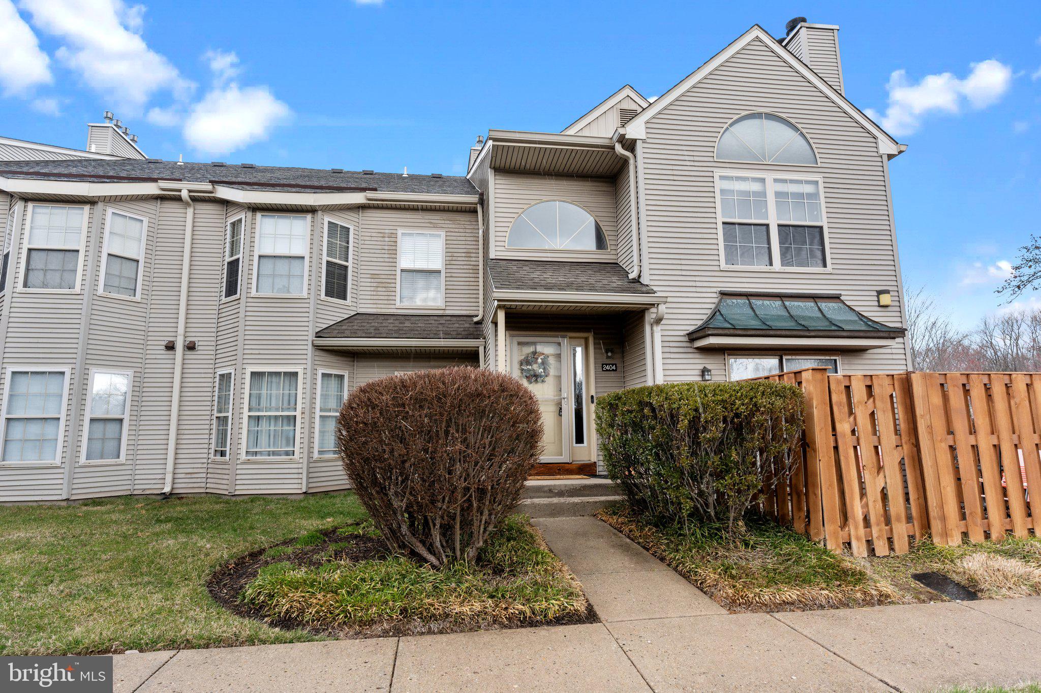 2404 Brookhaven Drive, Unit 330 Yardley, PA 19067 - Photo 1 of 27 a front view of a house with garden
