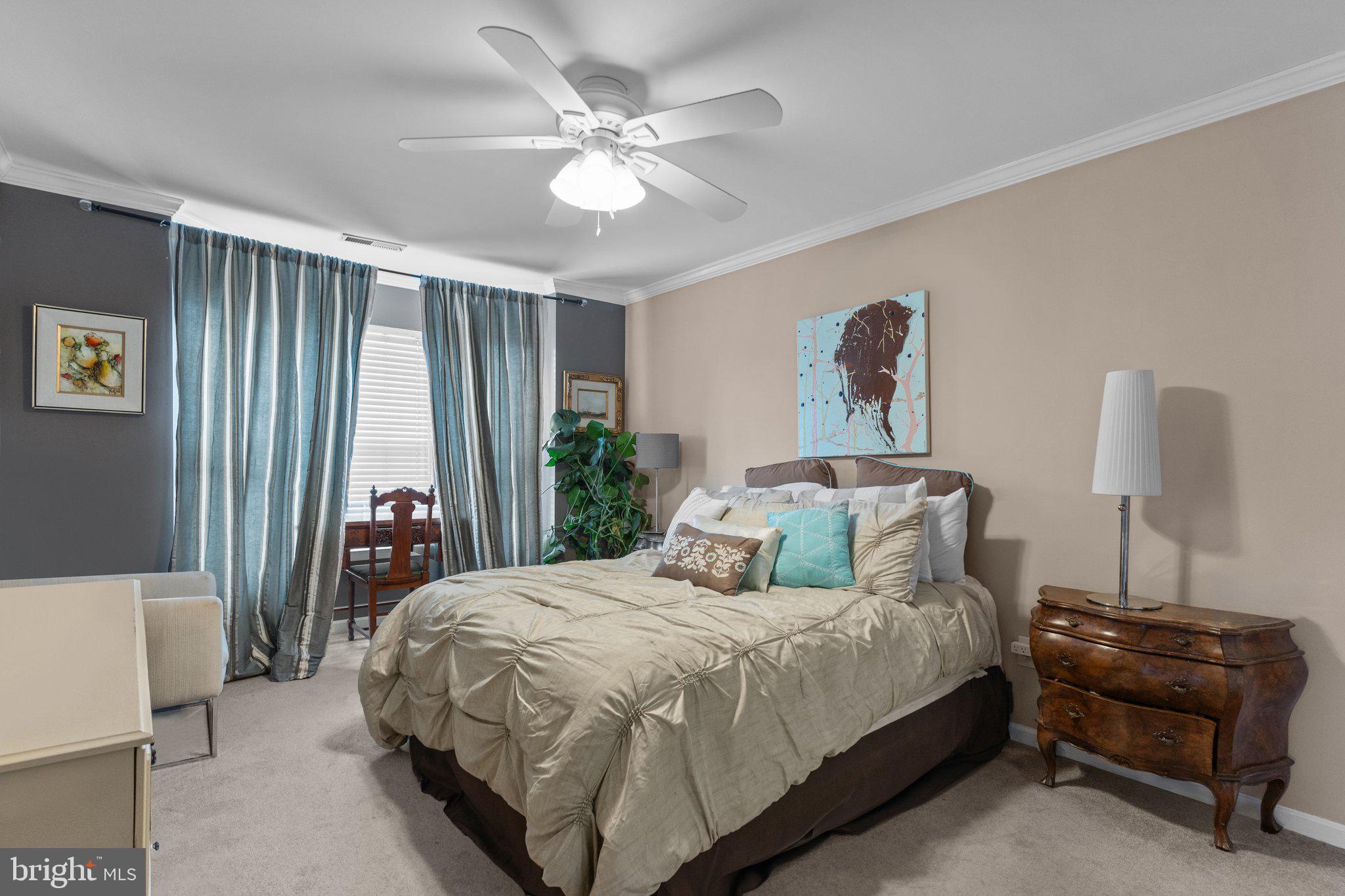 2404 Brookhaven Drive, Unit 330 Yardley, PA 19067 - Photo 13 of 27 a bedroom with a bed and a chandelier