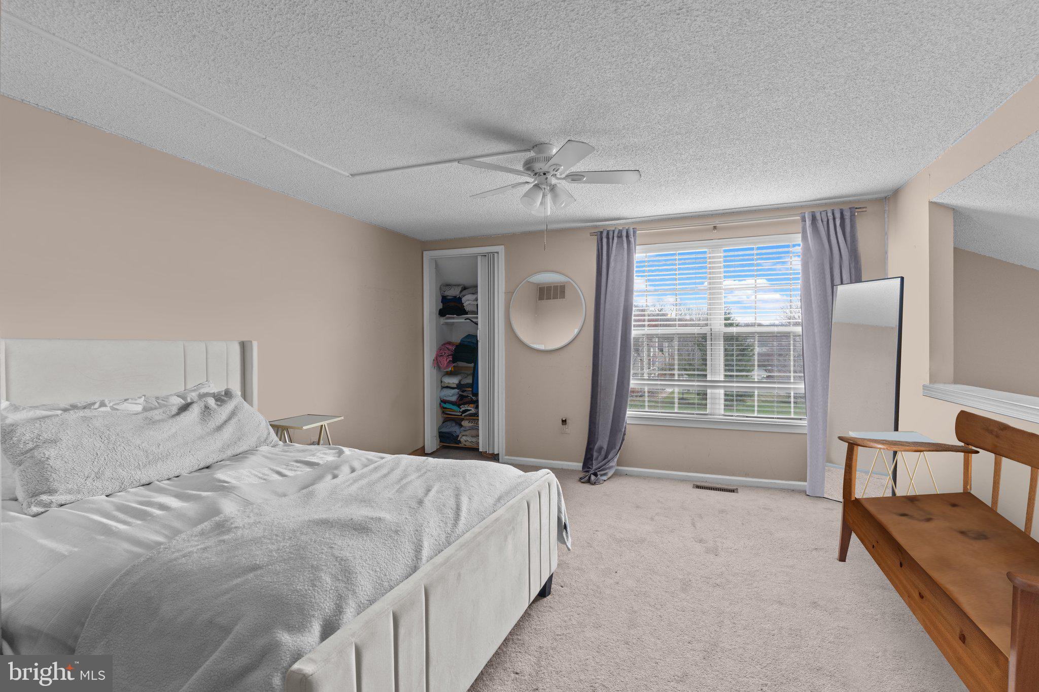 2404 Brookhaven Drive, Unit 330 Yardley, PA 19067 - Photo 18 of 27 a spacious bedroom with a bed and a chair